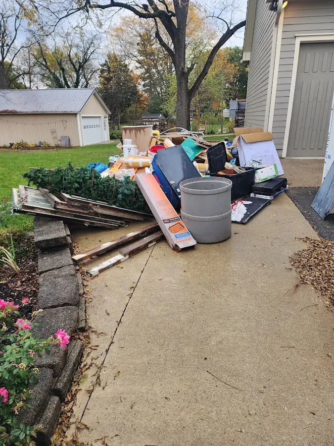 Dumpster being loaded with debris for Roofing Dumpster Rental in Weiser